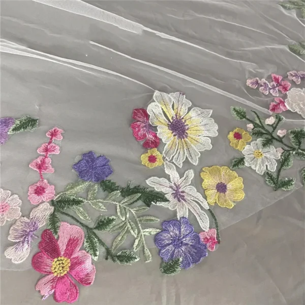Sfedd0b88fdc44213acff4e70daa32e74G.webp The Bellflower Veil, a cathedral wedding veil with three-dimensional embroidered wildflowers along the hem
