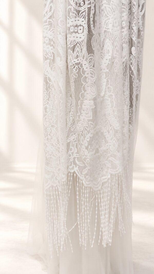 The Alba Veil, an ivory tassel fringe wedding veil in floral lace with a scalloped border