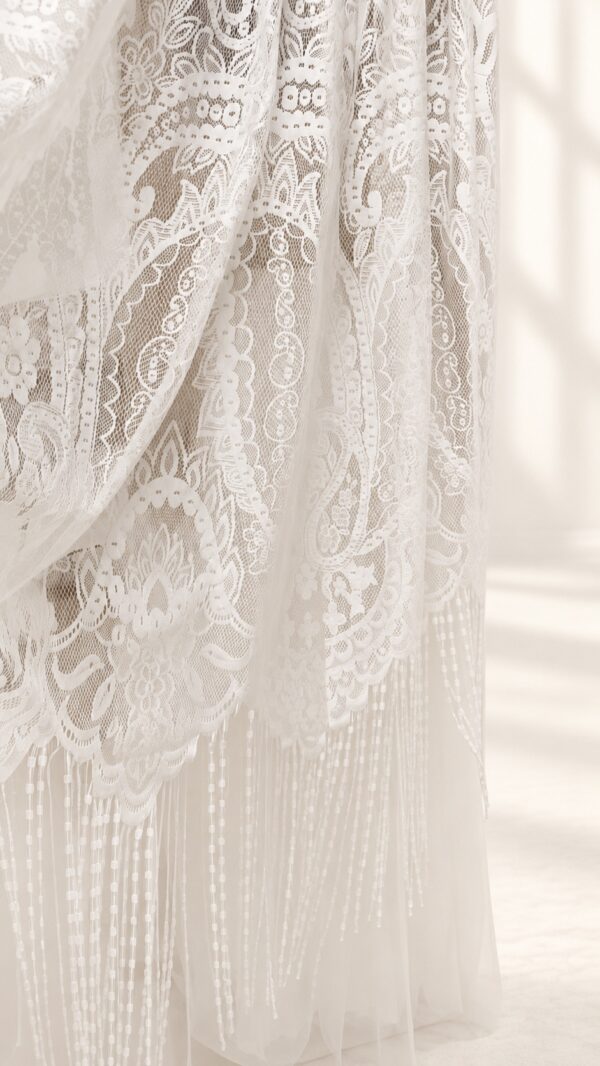 The Alba Veil, an ivory tassel fringe wedding veil in floral lace with a scalloped border