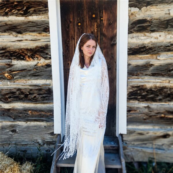 The Alba Veil, an ivory tassel fringe wedding veil in floral lace with a scalloped border