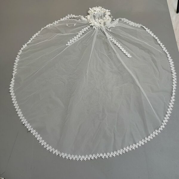 The Elsie Cap, a cream white juliet cap veil with 3D fabric flowers, pearls and a lace-edged tulle veil
