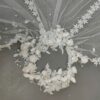 The Elsie Cap, a cream white juliet cap veil with 3D fabric flowers, pearls and a lace-edged tulle veil
