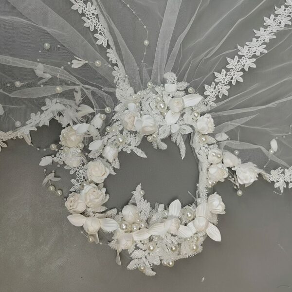 The Elsie Cap, a cream white juliet cap veil with 3D fabric flowers, pearls and a lace-edged tulle veil
