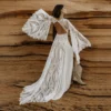 Back view of bride in open-back lace wedding dress with flowing train
