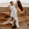 Couple celebrating outdoors with bride in bell-sleeve lace wedding dress