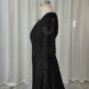 Side studio view of black crochet-style lace wedding dress