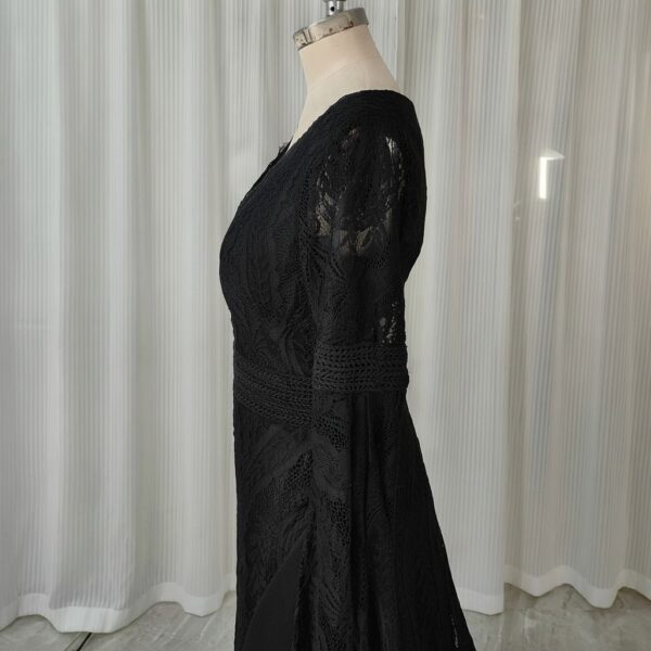 Side studio view of black crochet-style lace wedding dress