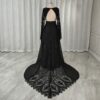 Rear view of black open-back lace gown with patterned train