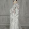 Side view showing intricate lace sleeve and fitted bridal bodice
