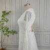 Side view of backless off-white lace maxi wedding dress