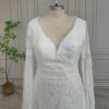 Close front view of bell-sleeve lace wedding gown