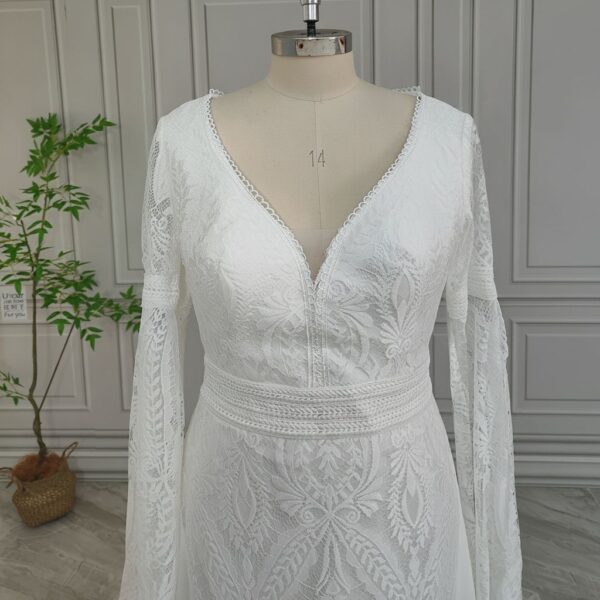 Close front view of bell-sleeve lace wedding gown