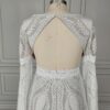Close view of open keyhole back on off-white lace wedding dress