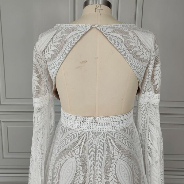 Close view of open keyhole back on off-white lace wedding dress