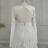 Open keyhole back and long lace sleeves on off-white bridal dress