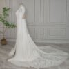 Side rear view of open-back lace wedding gown with flowing train