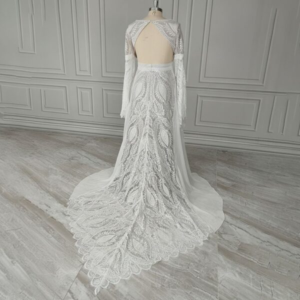 Rear studio view of off-white lace wedding gown and patterned train